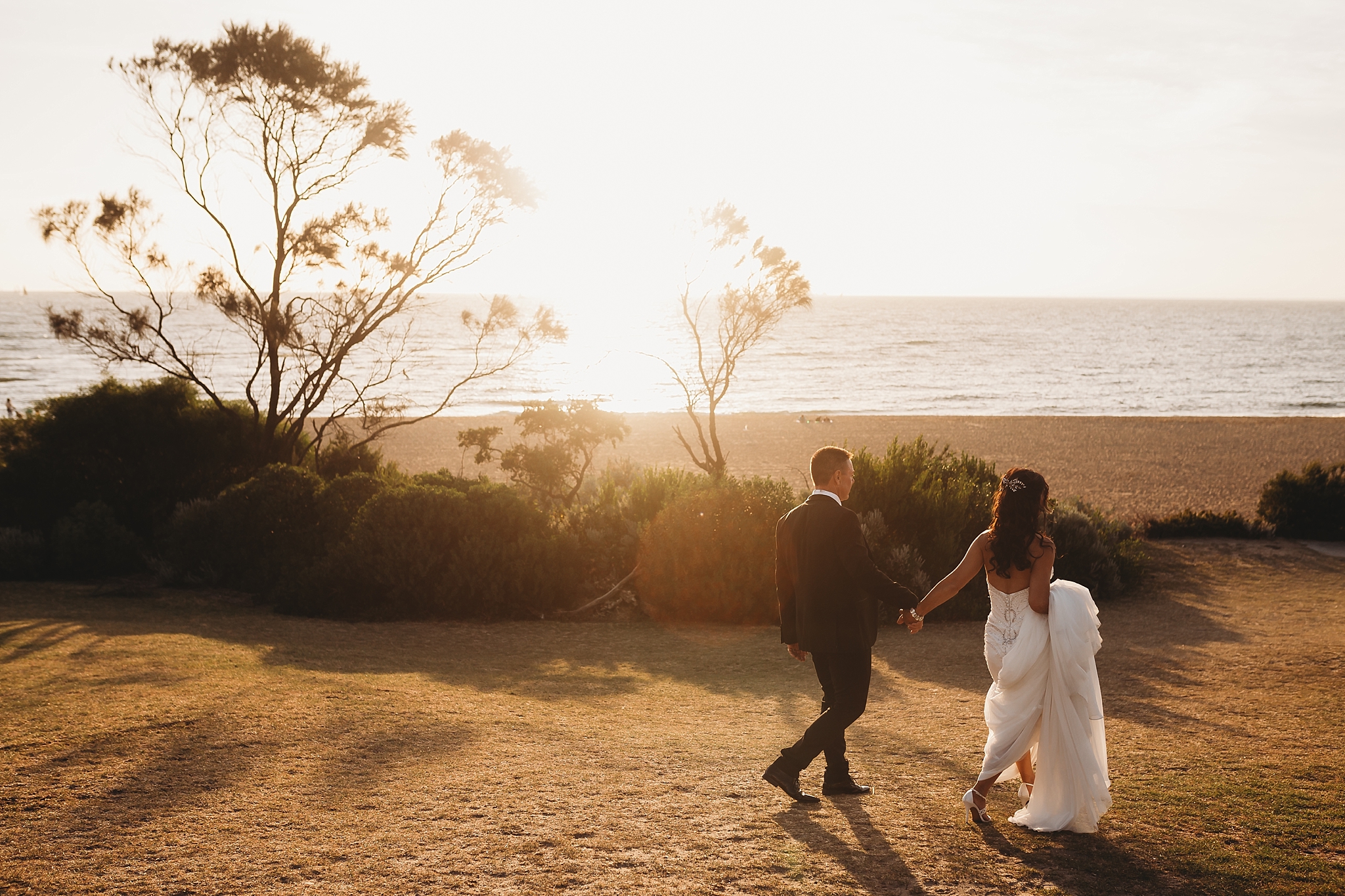 bride and groom at sunset on brighton beach