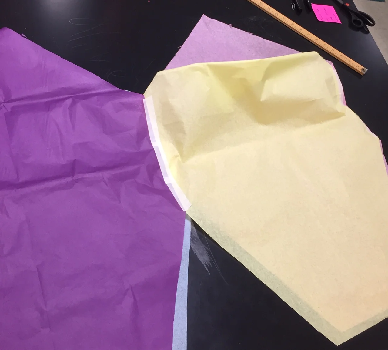 Fold the fourth edge back to the first edge and tape these together. BE SURE to not accidentally tape the tissue paper to sheets underneath these edges.