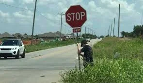 When Young Man Sees Broken Stop Sign, He Spends His Lunch Break Holding it Up in the Heat