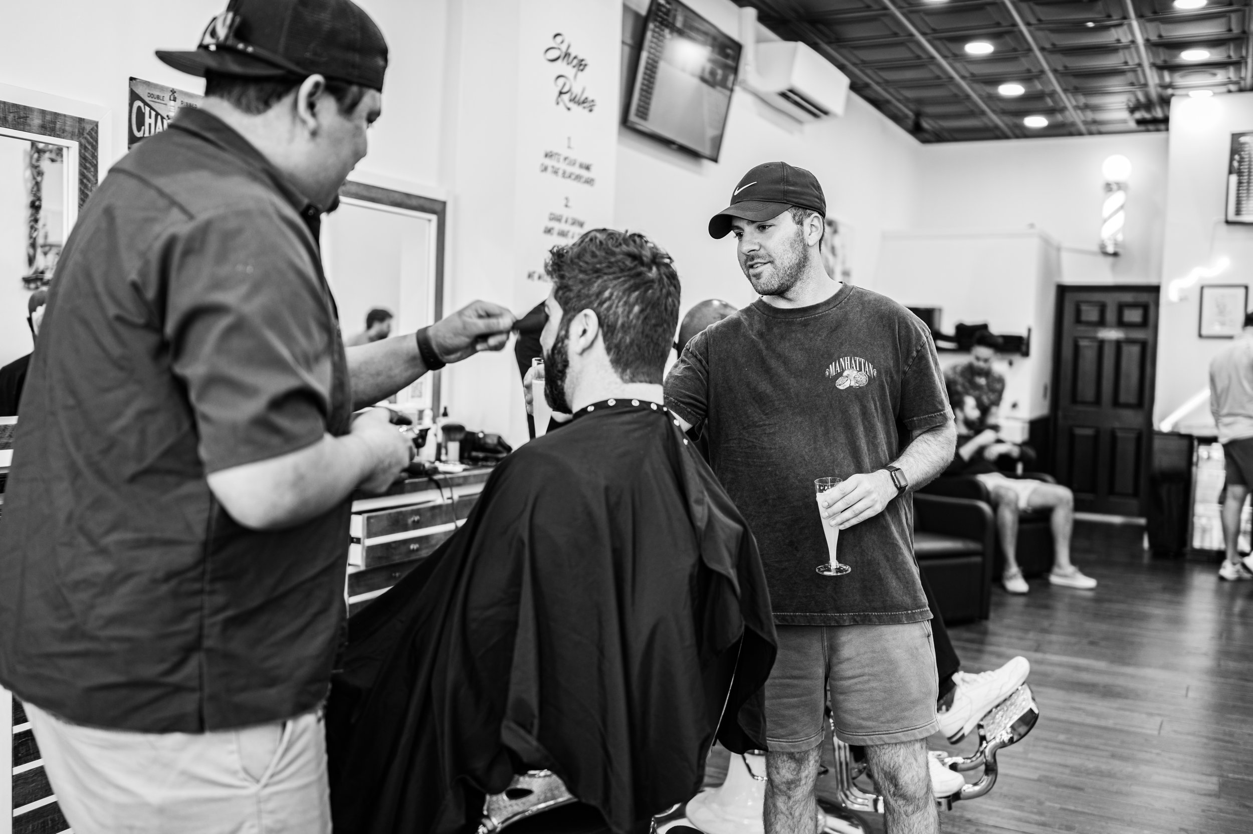 Dylan cuts the Groom's hair while his best men watch.