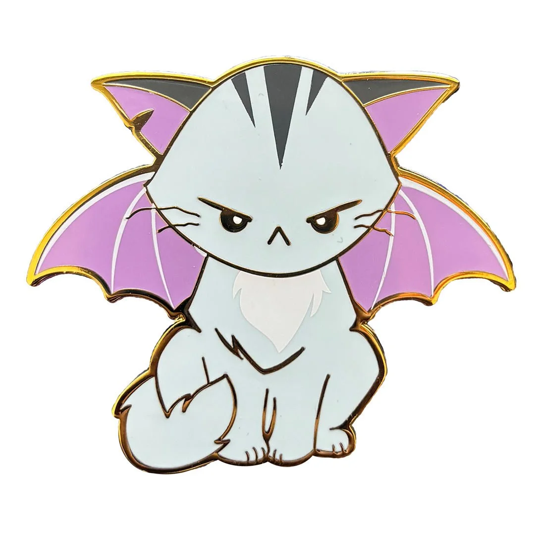 Enamel pin of a grey cat with purple bat wings.