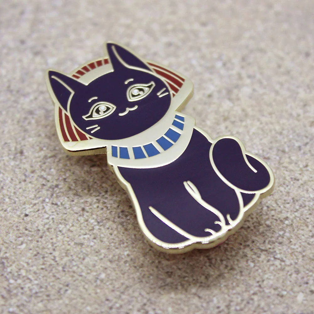 Enamel pin of an Egyptian cat goddess.