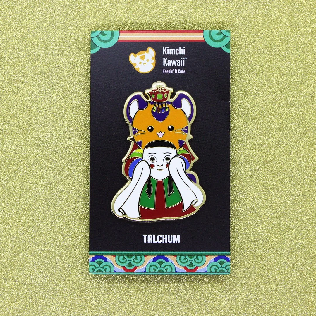Enamel pin of Korean tiger in hanbok holding a talchum mask.