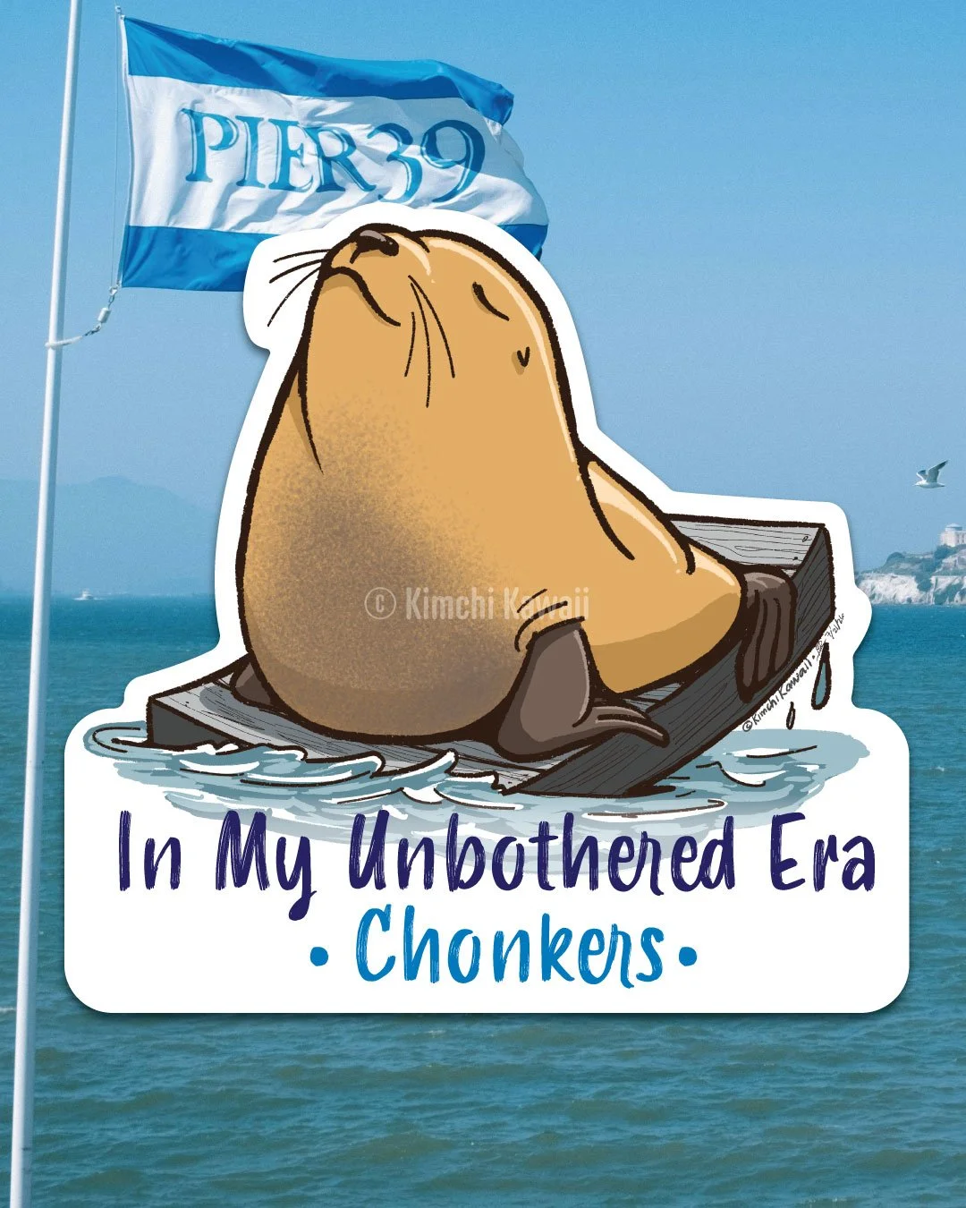 Sticker of a brown sea lion with his nose in the air sitting on a dock. Words say 'In My Unbothered Era, Chonkers'