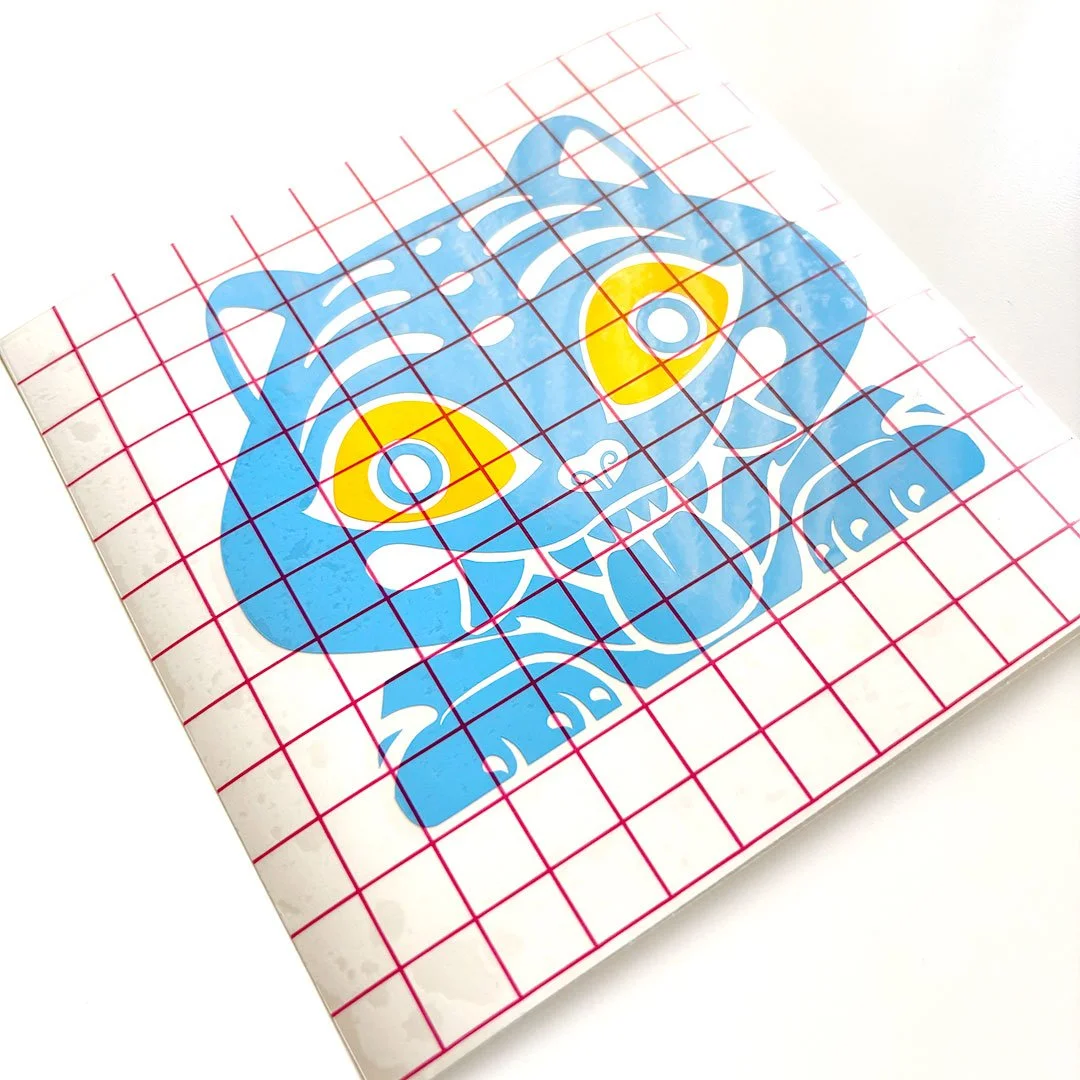 Sticker of a blue tiger with yellow eyes.