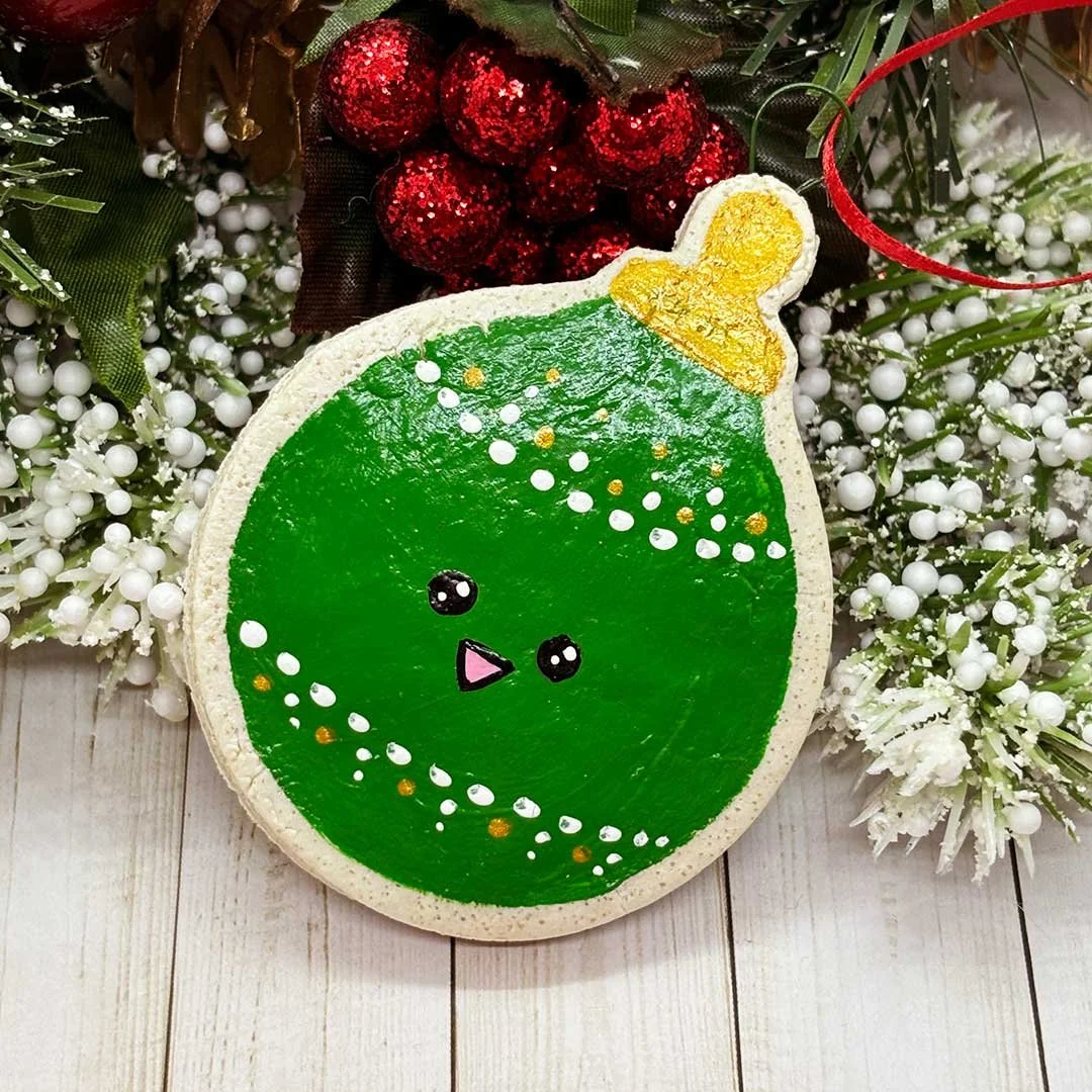 Round Christmas cookie ornament painted green.
