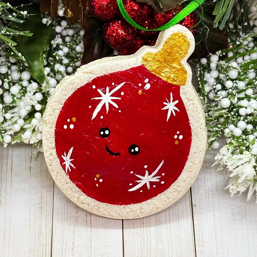 Red smiling Christmas ornament.