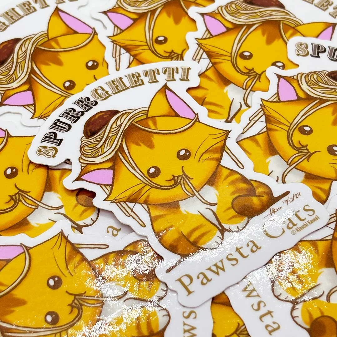 Sticker of an orange cat with spaghetti noodles on its head. Words around it read 'Spurrghetti' and 'Pawsta Cats'.