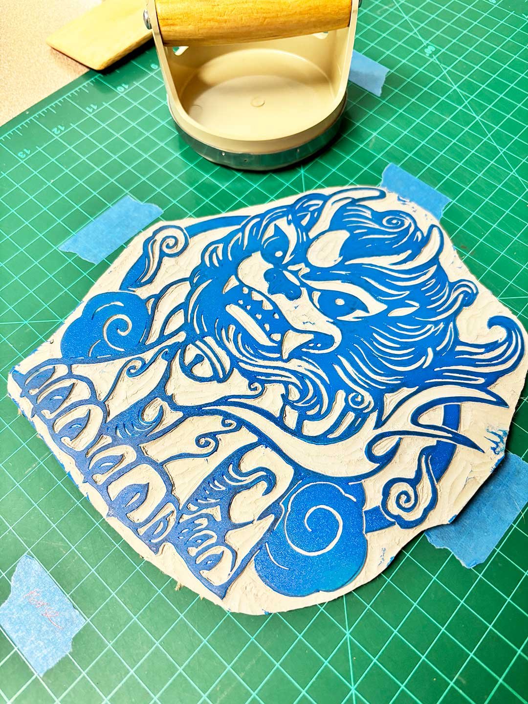 Blue inked print block of a Korean haetae looking angry.