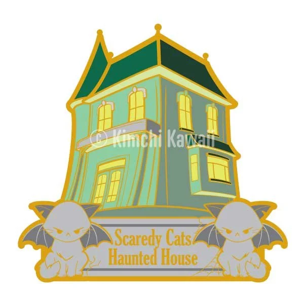 Mockup of a pin of of a green haunted house with two cat bat guardians. Text reads 'Scaredy Cats Haunted House'.