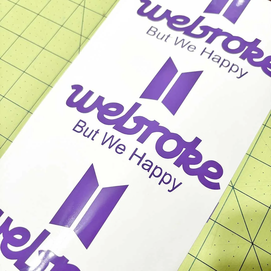 Purple sticker that says 'Webroke, but we happy'