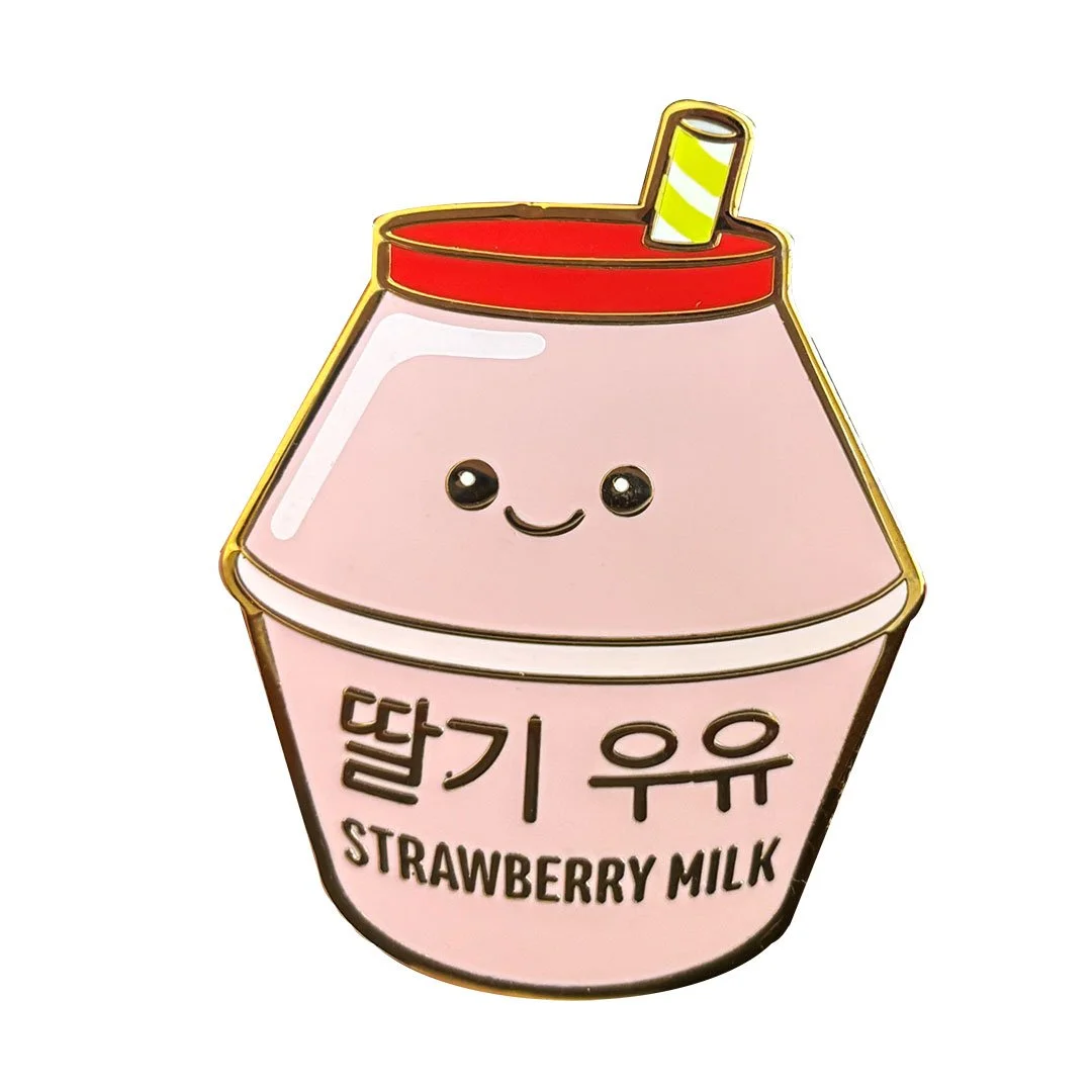 Cute enamel pin of a pink strawberry milk bottle with a red lid and small straw.