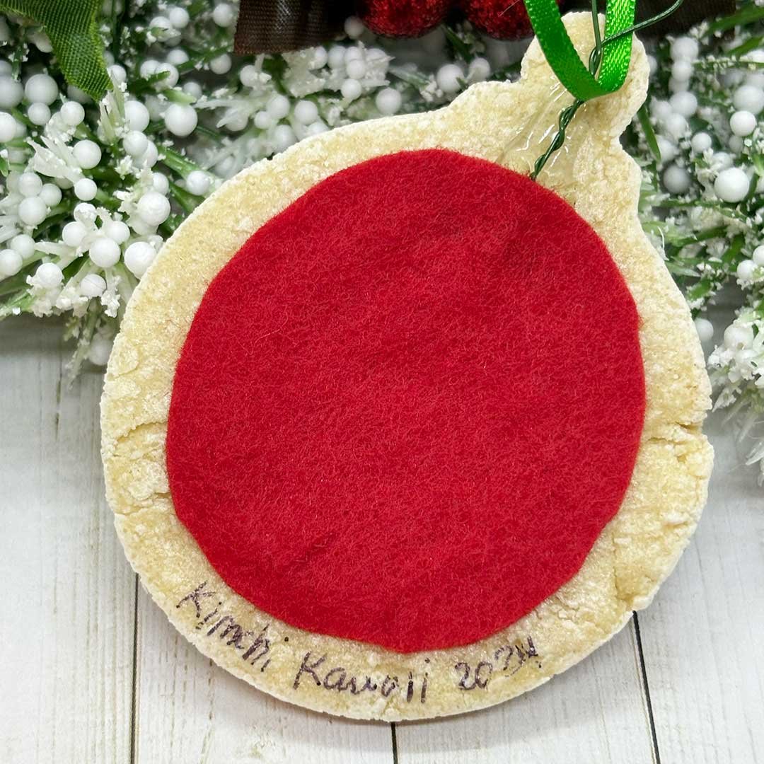 Back of round ornament with felt and 'Kimchi Kawaii, 2024'.