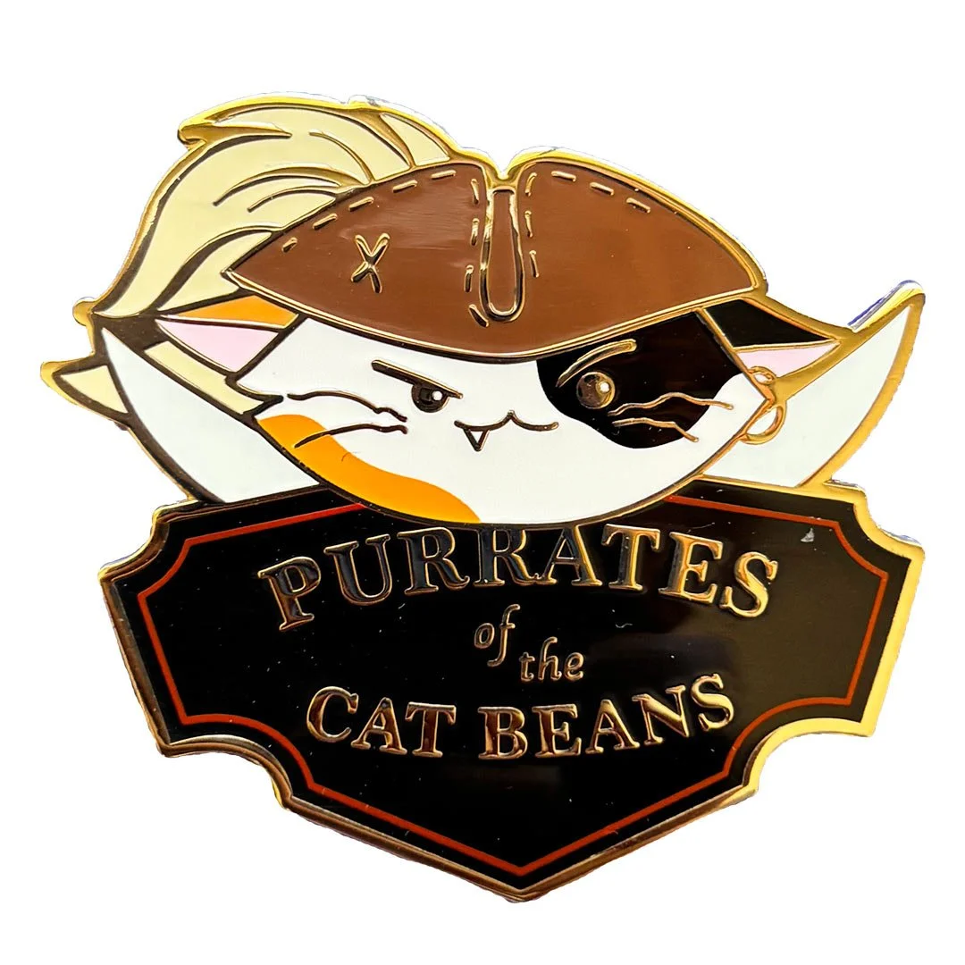 Mockup of a pin of a pirate cat over a sign that says 'Purrates of the Catbeans'.