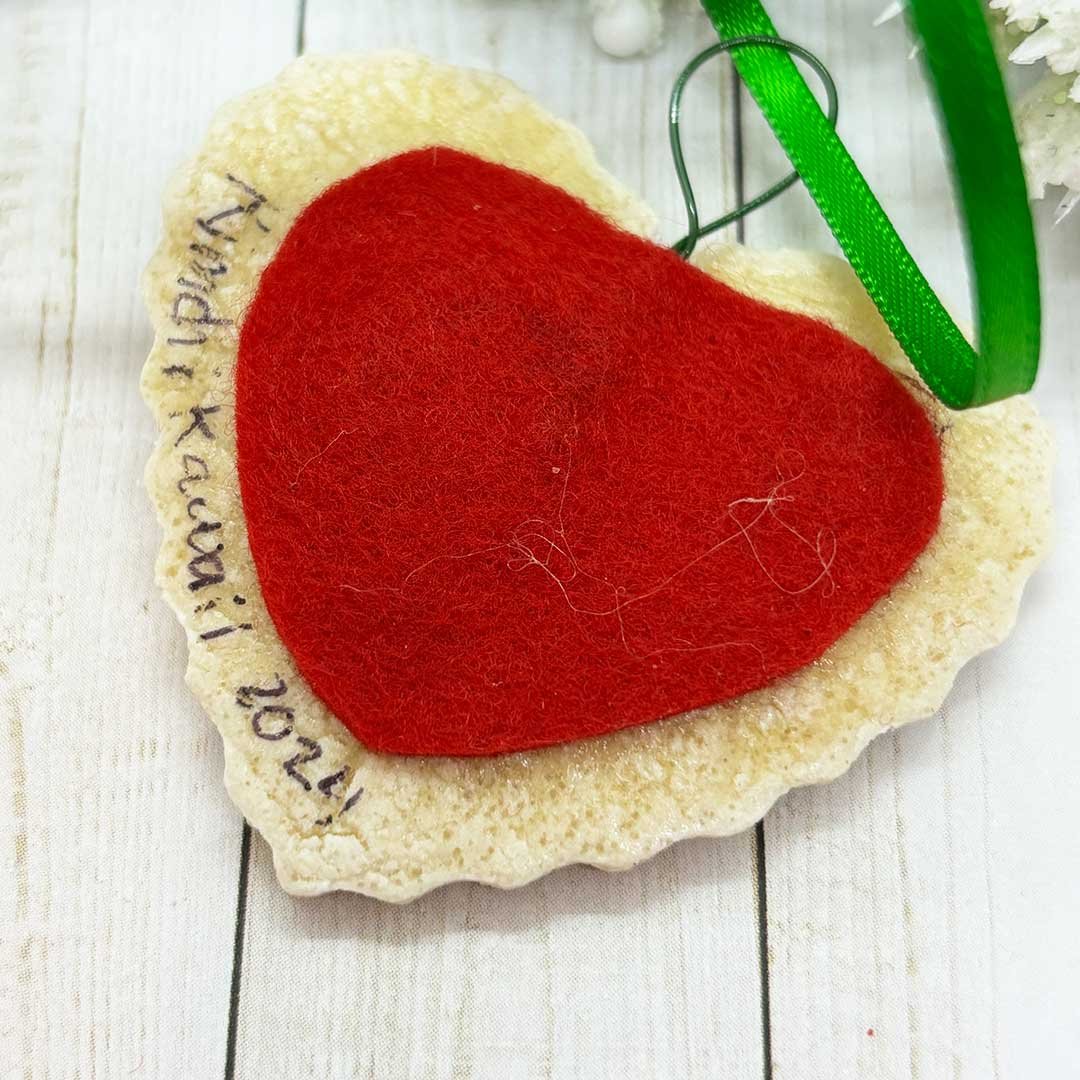 Back of a heart cookie ornament with felt and 'Kimchi Kawaii, 2024'.