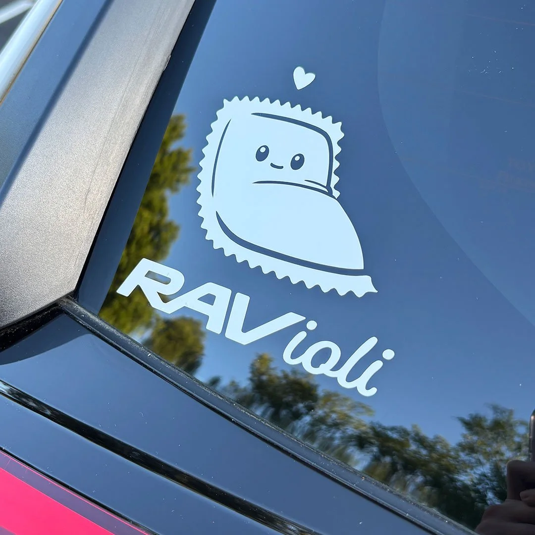Cute ravioli sitting in a corner with the words 'ravioli' in stylized letters on the back of a car.
