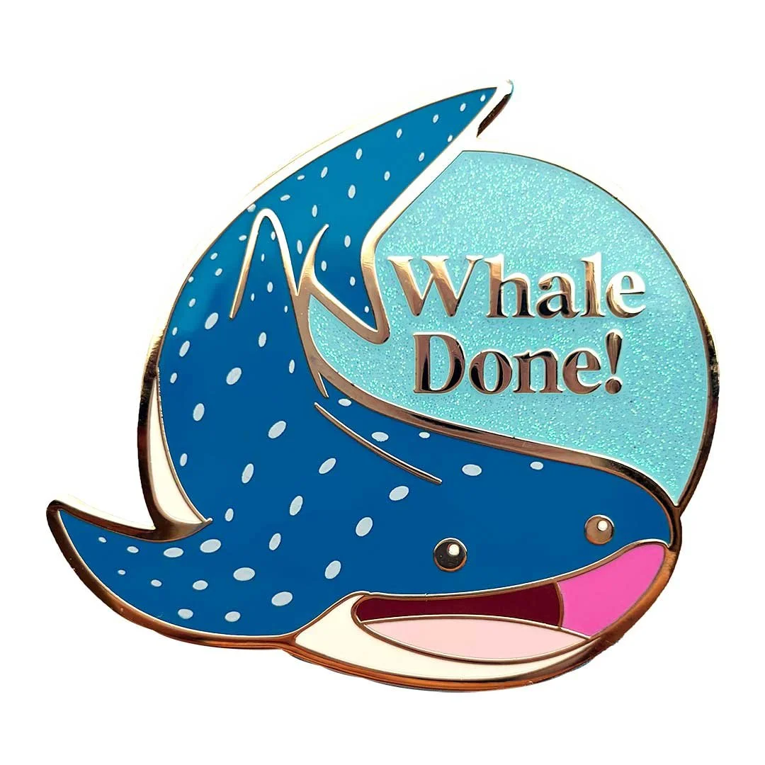 Cute whale shark pin that says 'whale done'.