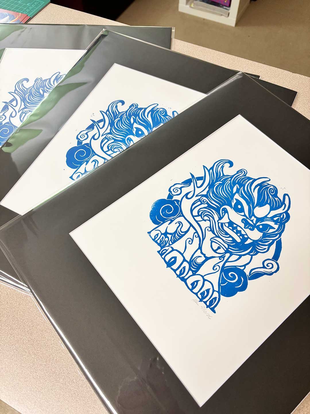 Matted blue prints of a Korean haetae looking angry.