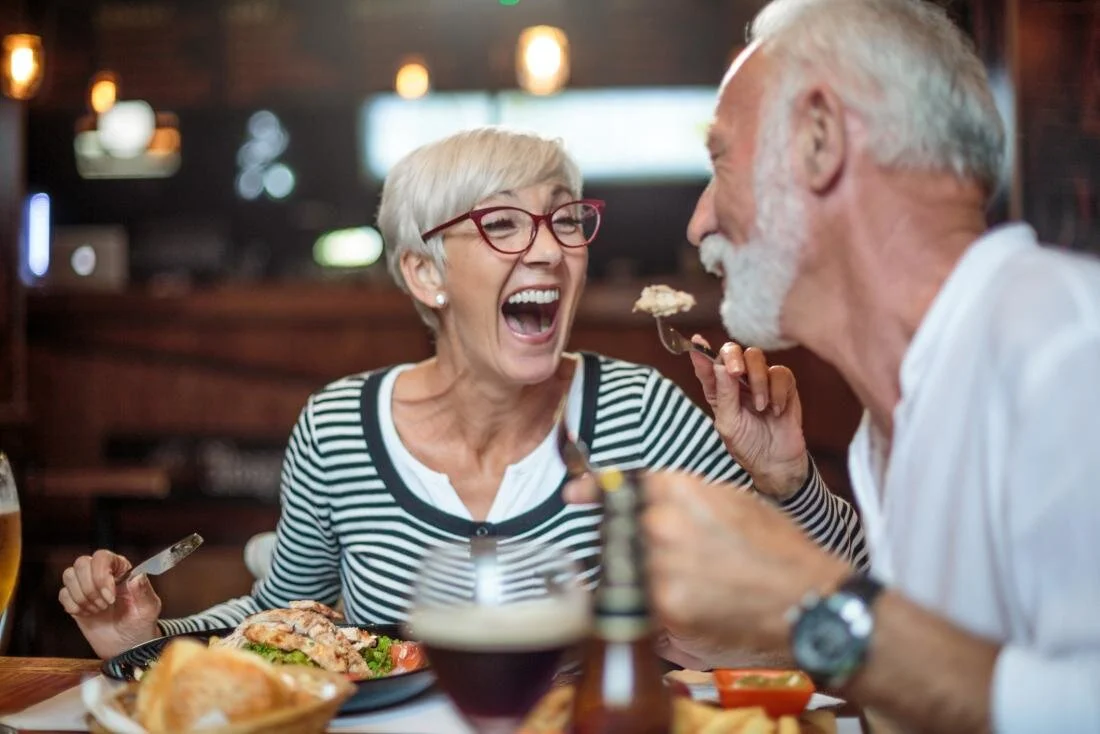 older-adults-laughing-and-eating.jpg