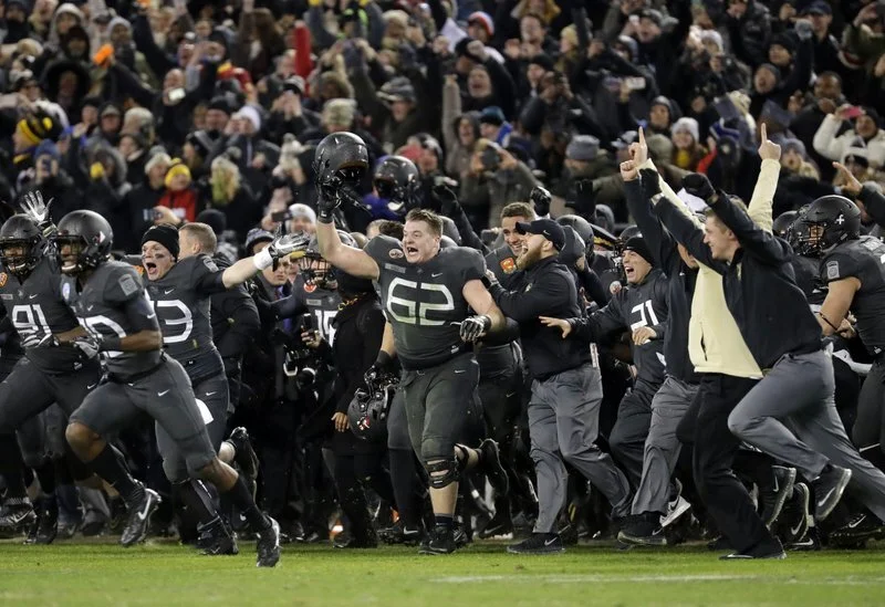 The Army sideline reacts to defeating Navy, many remembering the sign I had written.