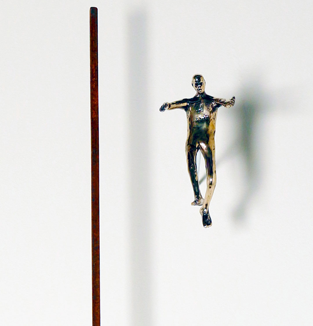 Detail, "Falling Man #27", 2015, bronze and steel, fig. 5"H, steel 7' L x 1/4" x 1/4"