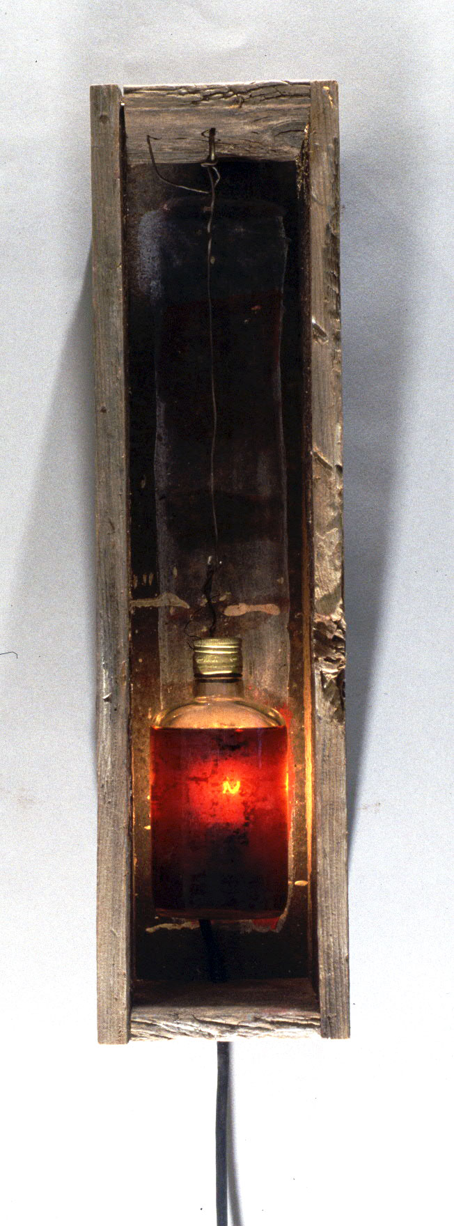 "Spirits #3", 1998, wood, bottle, alcohol and lighting element, 20" H