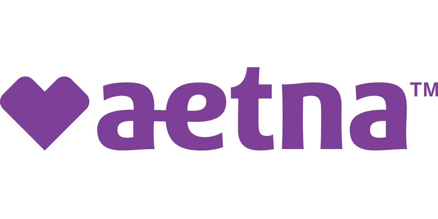 Purple text spelling 'Aetna' with a purple heart symbol to the left.