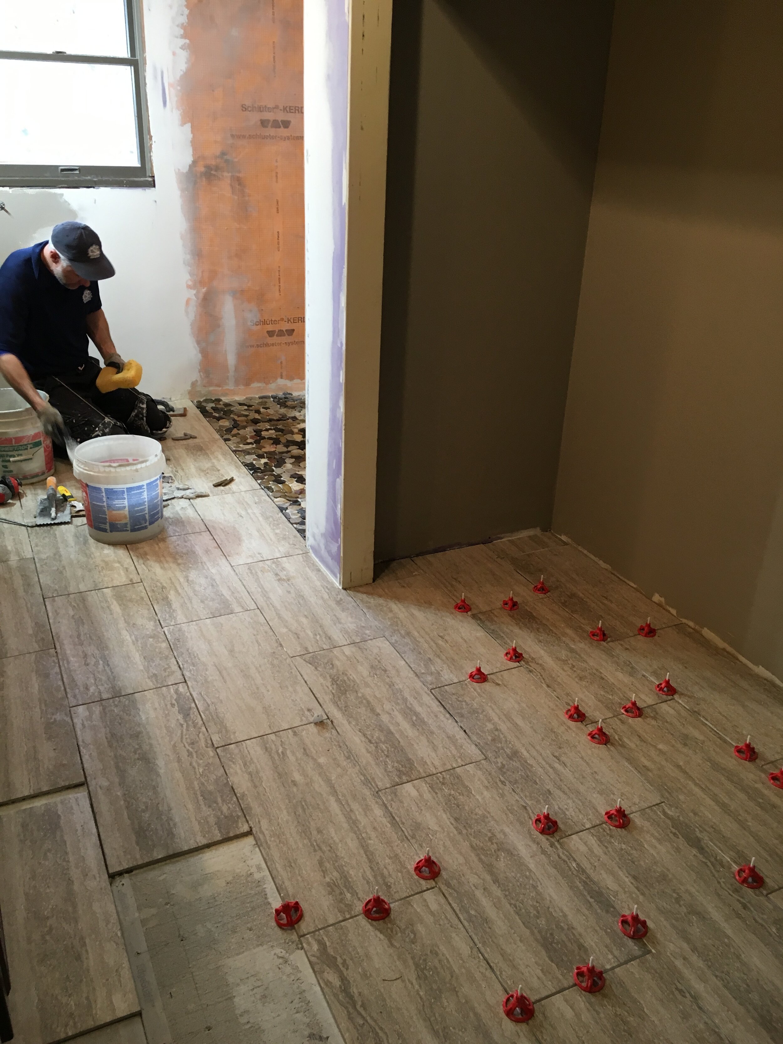  We installed new porcelain tiles in the bathroom and a rock floor for the shower. 