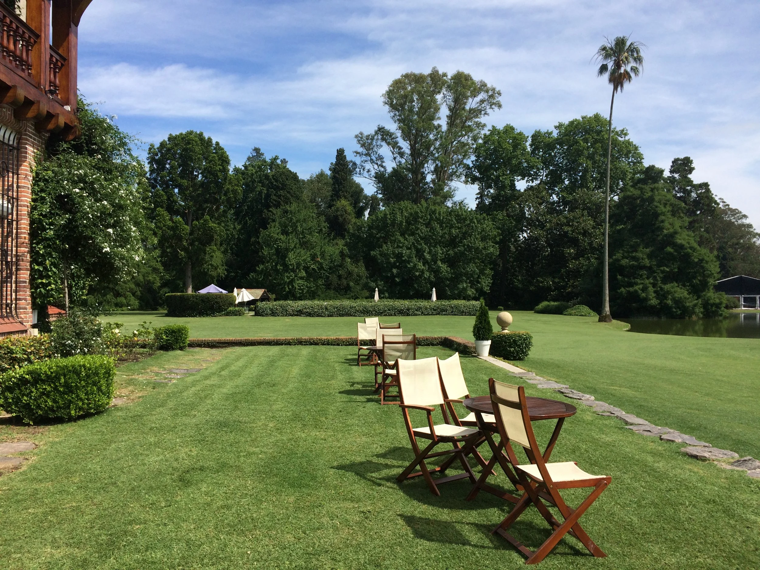  Beyond the lawn chairs enjoy the  Estancia's  swimming pool 