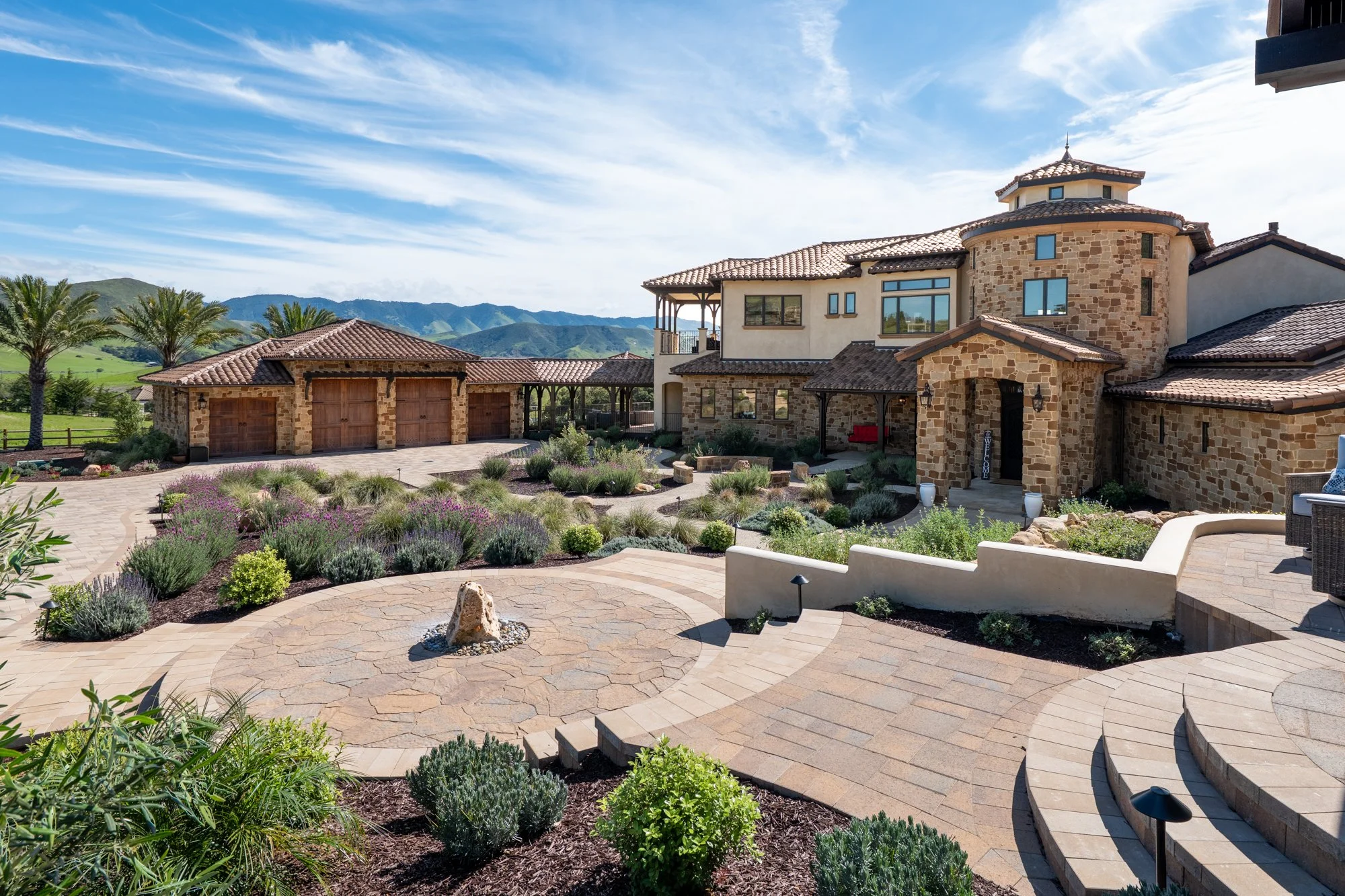 An image of a bubbling boulder and central courtyard in San Luis Obispo.