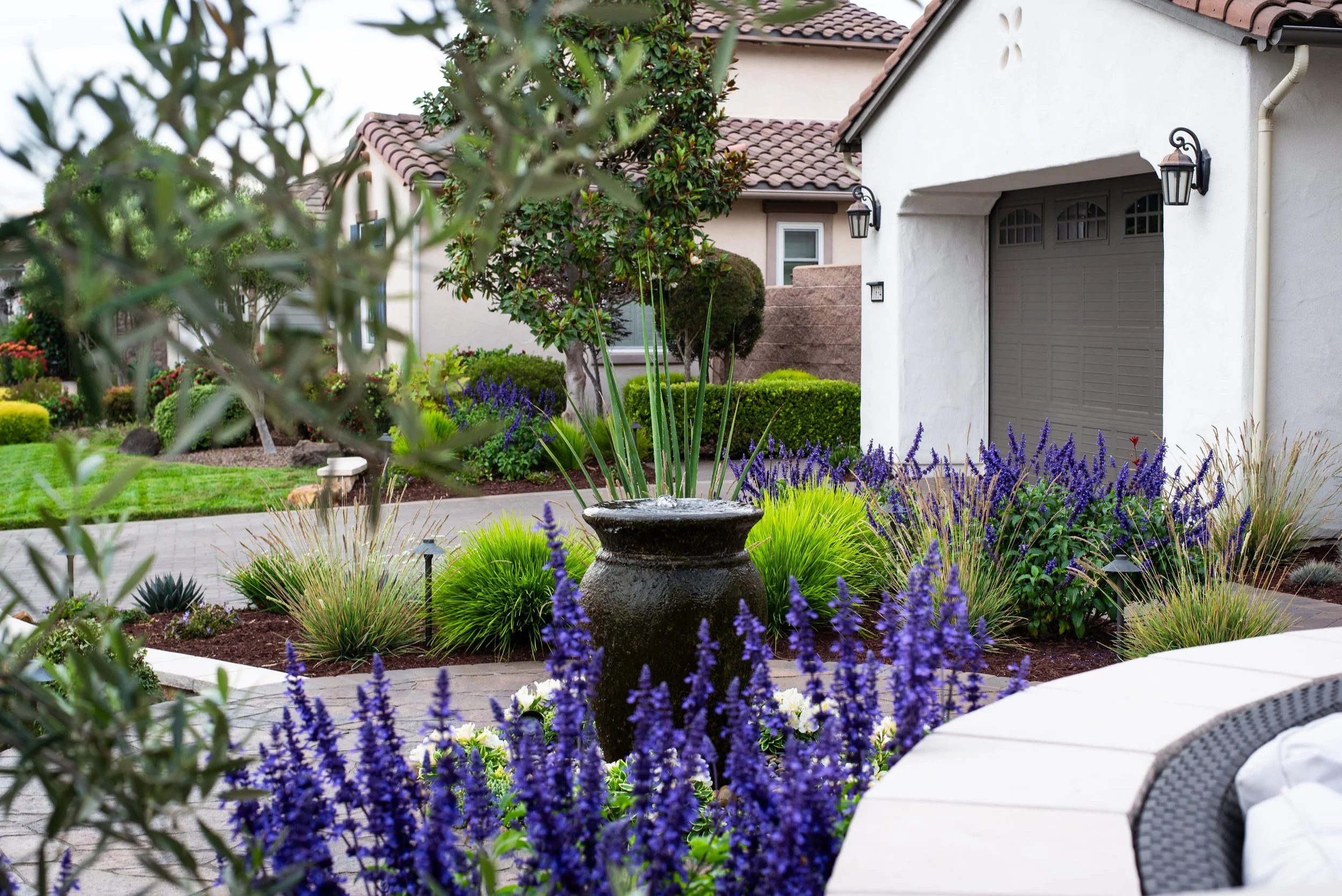 An image of a bubbling pot as a center piece focal point in this nipomo landscape design.
