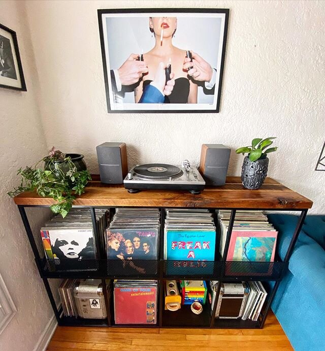 Custom record shelf made from steel, perforated steel and personally reclaimed 1920&rsquo;s oak barnwood. Bin style shelves so you can see and search your inventory by the cover art. Lower shelves can be used for more records, DJ cases or even baby t