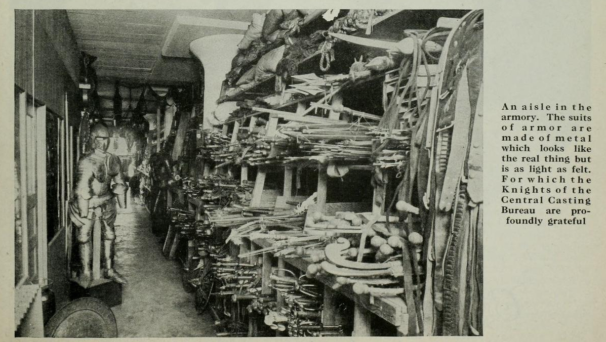 "An aisle in the armory. The suits of armor are made of metal which looks like the real thing but is light as felt. For which the Knights of Central Casting Bureau are profoundly grateful." Photo via Photoplay (Feb. 1928).