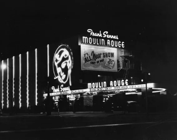 Exterior of the Theater with new signage for Frank Sennes' Moulin Rouge. Photo via Los Angeles Public Library (1954)