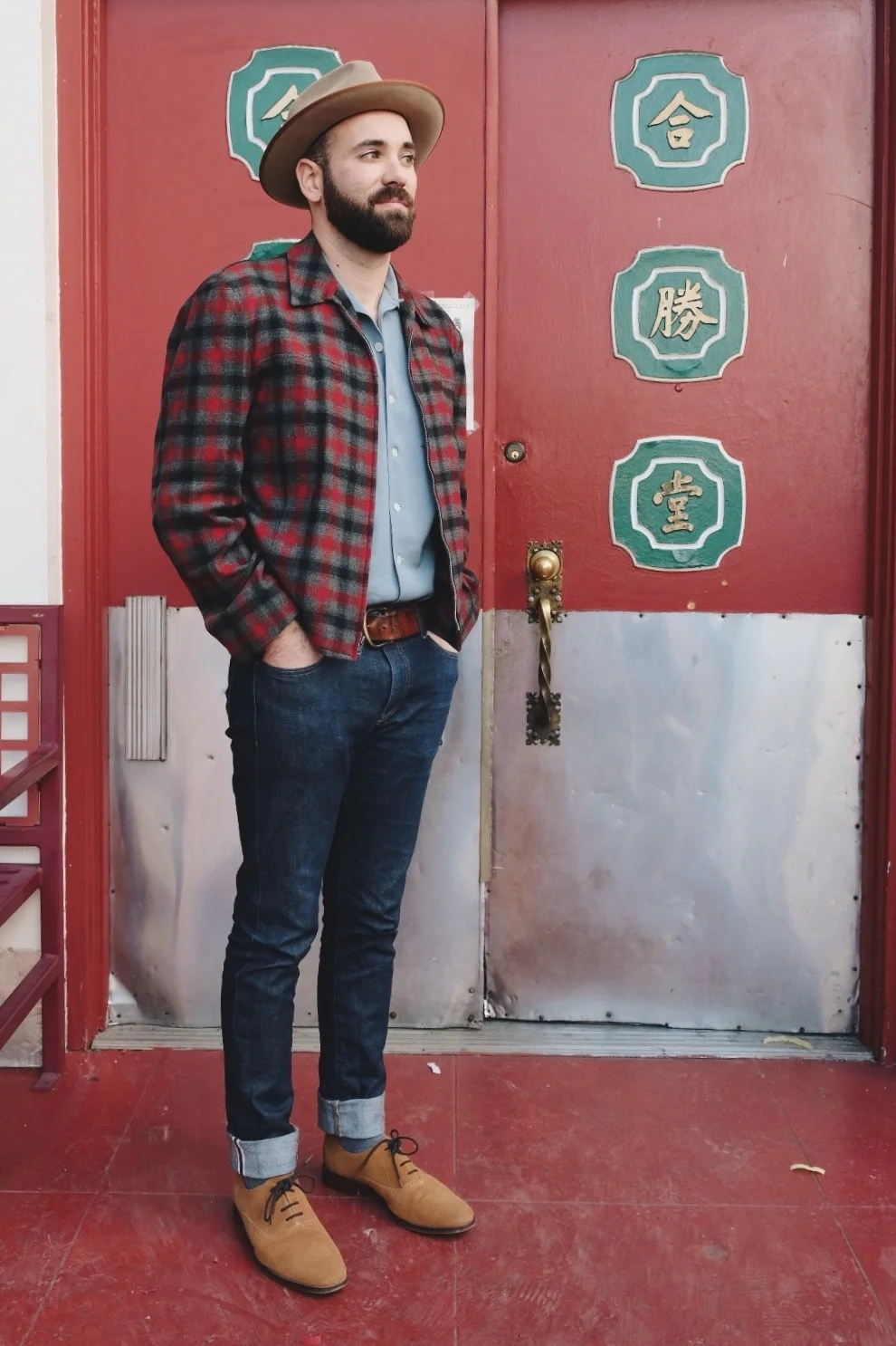 Nate in front of red ornate door in Chinatown