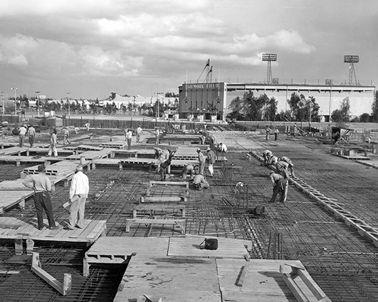 Construction of CBS Television City, with Gilmore Field visible in the background. Photo via CBS Broadcasting Inc. (c. 1957-58)
