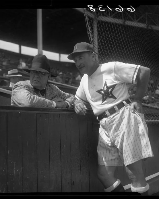Stars manager Fred Haney talking with Branch Rickey, general manager of the Brooklyn Dodgers, while wearing their his shorts uniform. Photo via UCLA Library, LA Times Collection (1950).