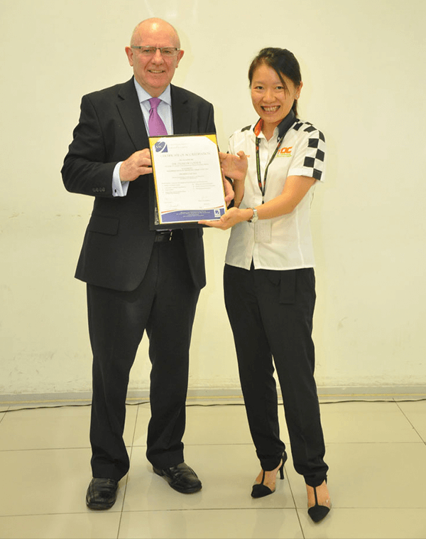 ASIC CEO Mr Maurice presenting Ms Adelaine with the premier status accreditation