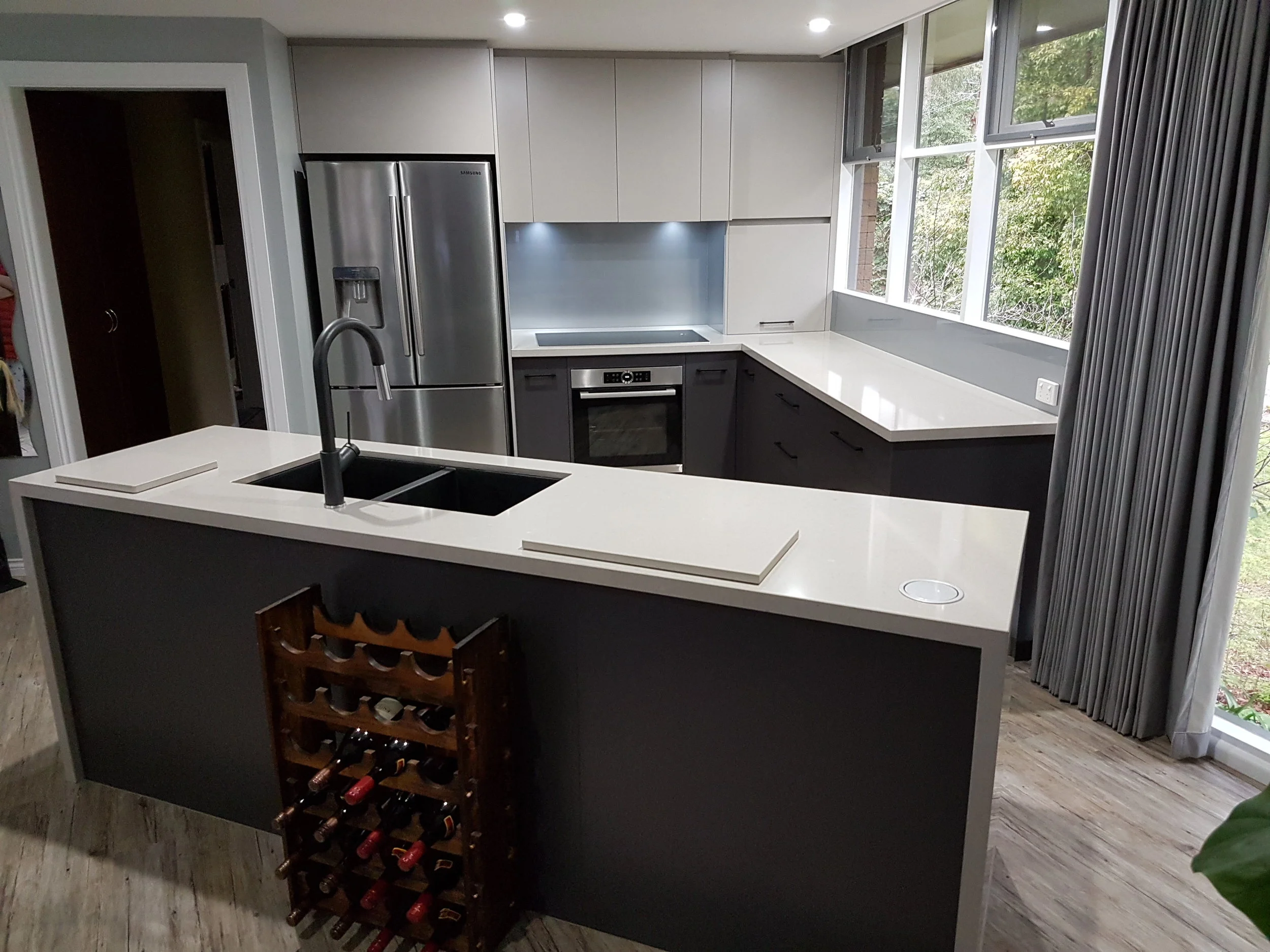 A beautifully positioned kitchen featuring an island bench with waterfall ends.