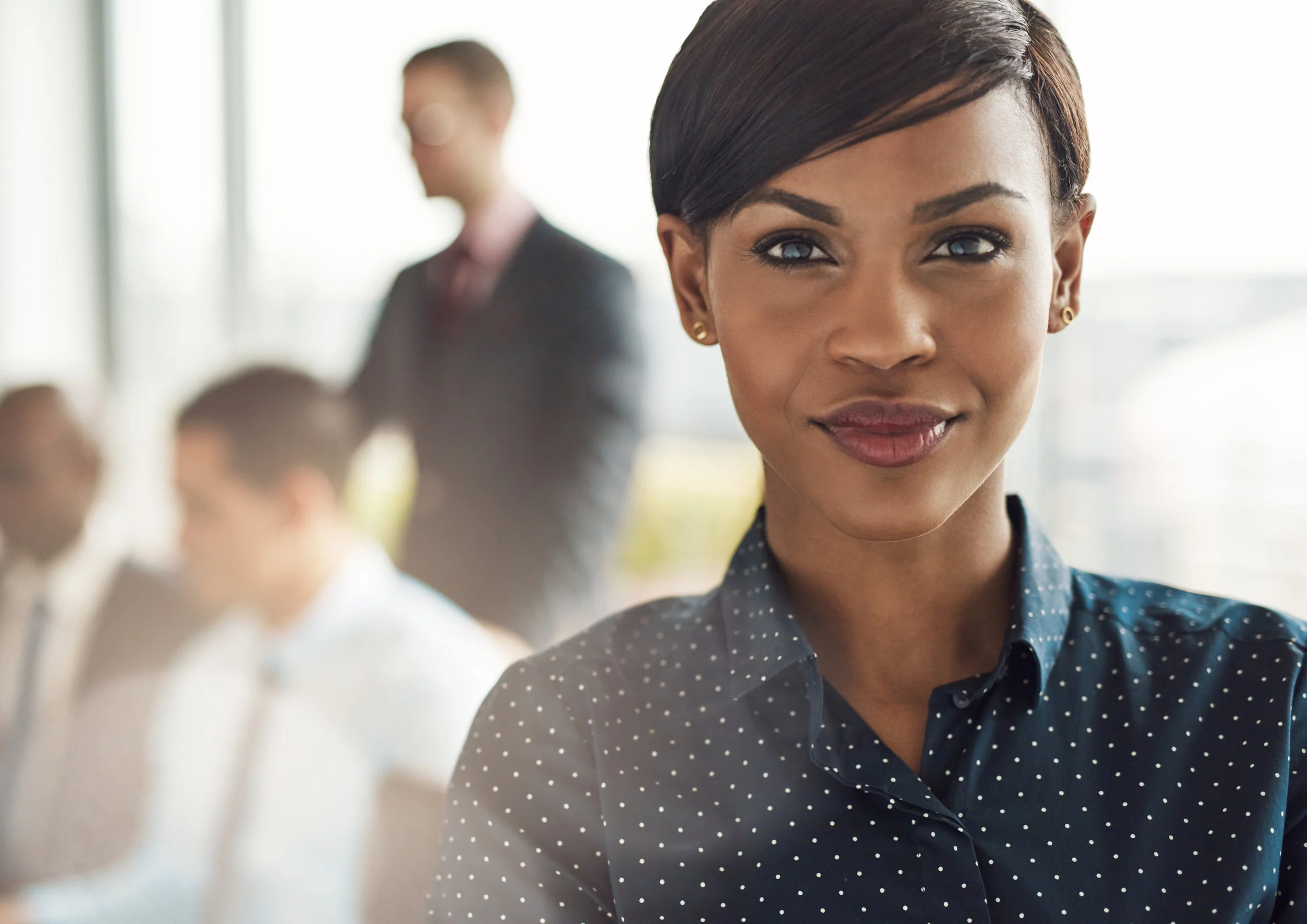 Confident-business-woman-in-office-with-group-530417408_3755x2656.jpeg