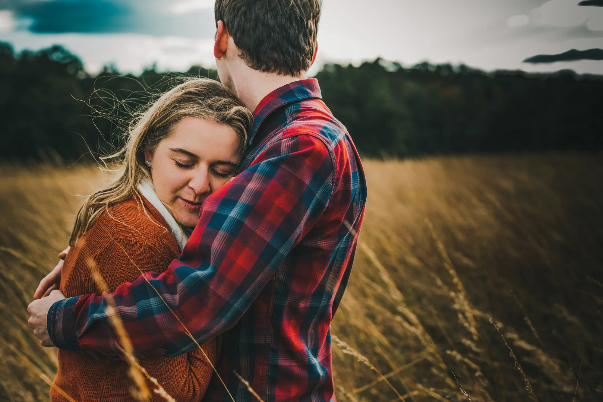 couple hugging in a winter field.jpg
