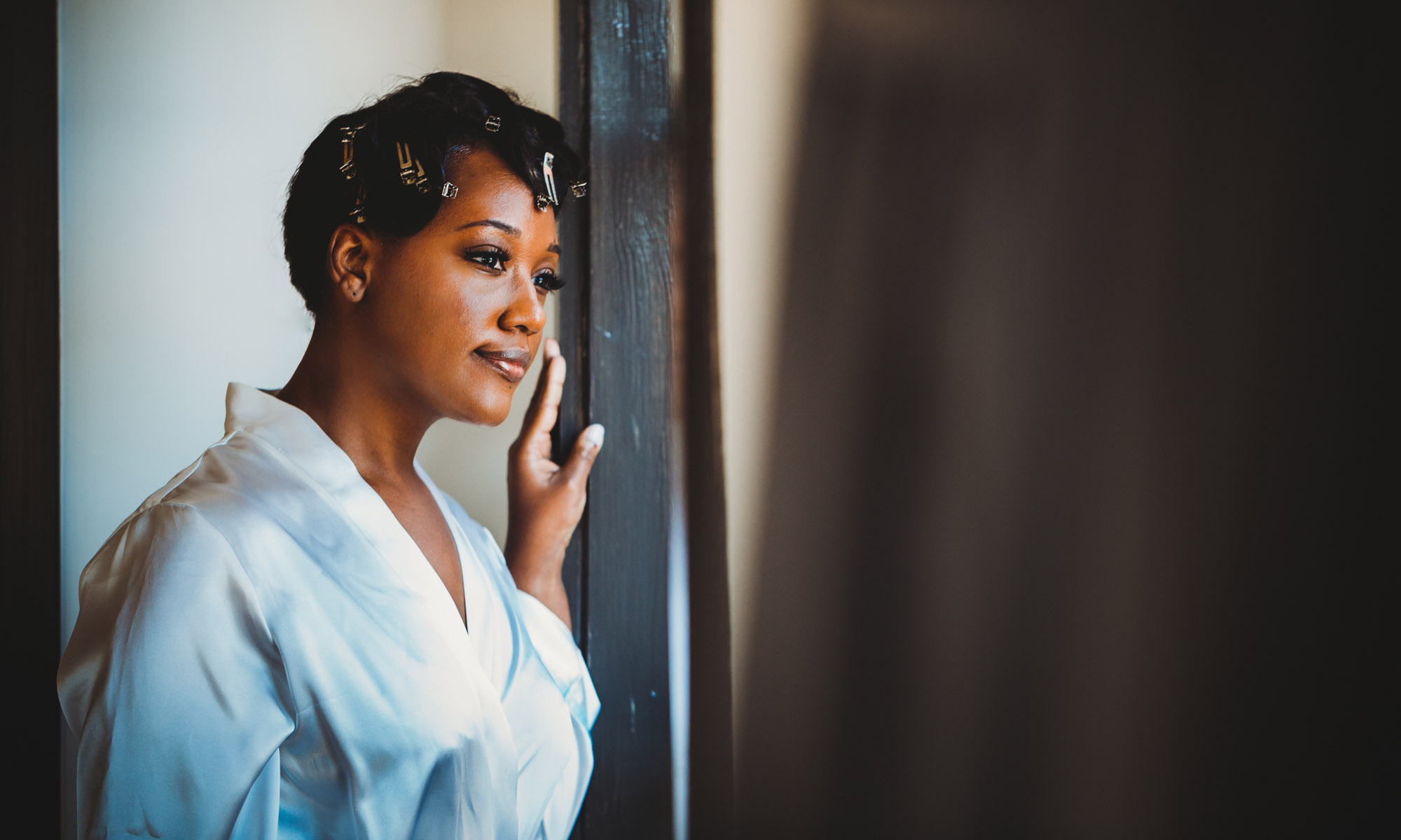 african american bride looking out window.jpg