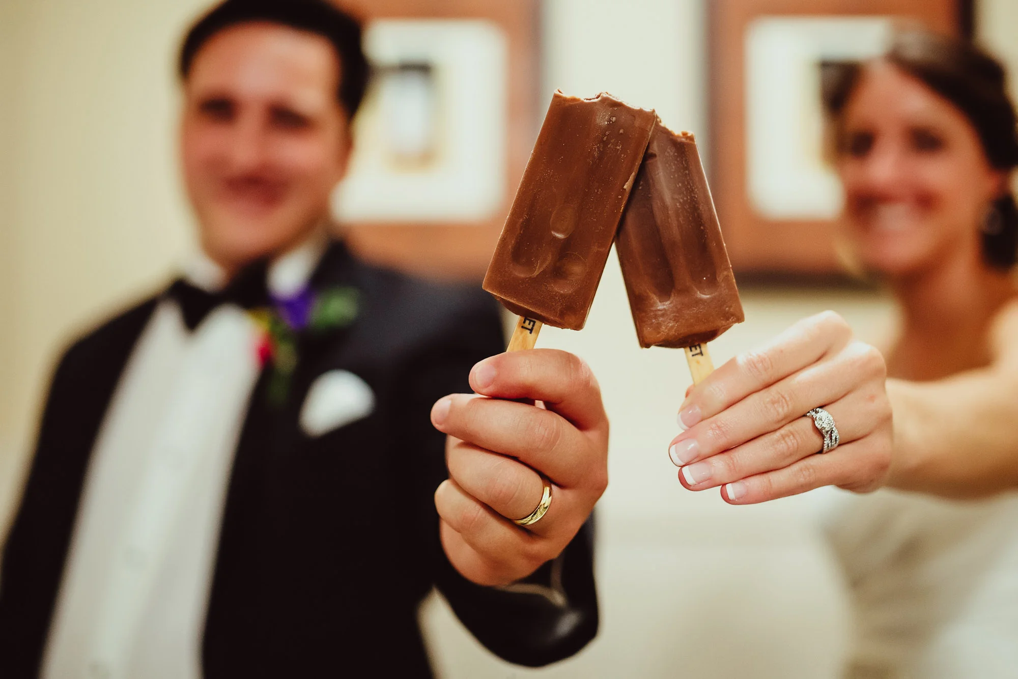 bride and groom holding popsickles.jpg