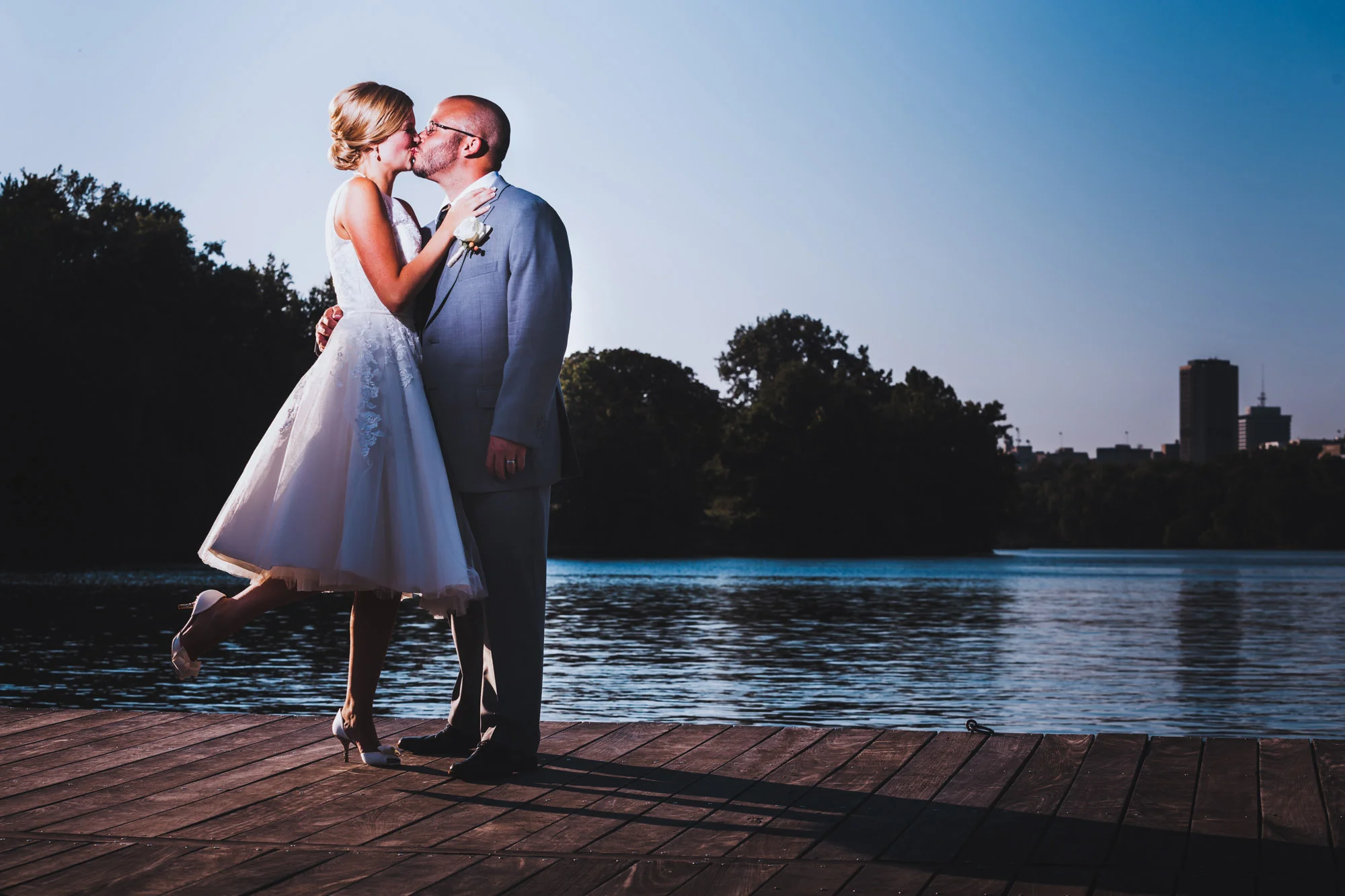 bride kissing groom by river.jpg