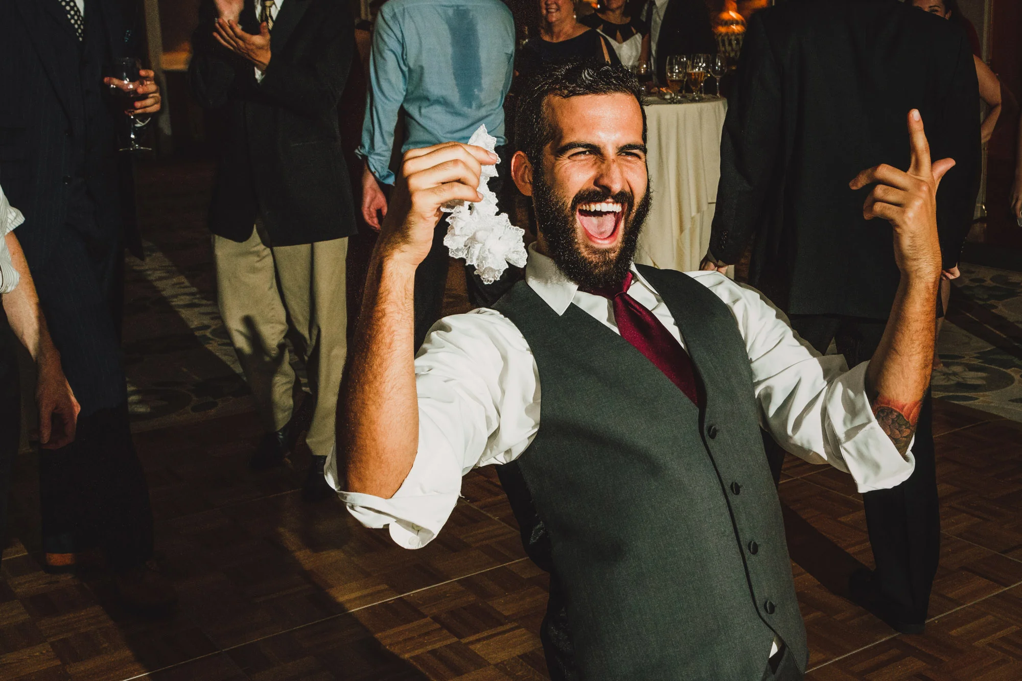 groomsmen catching garter.jpg