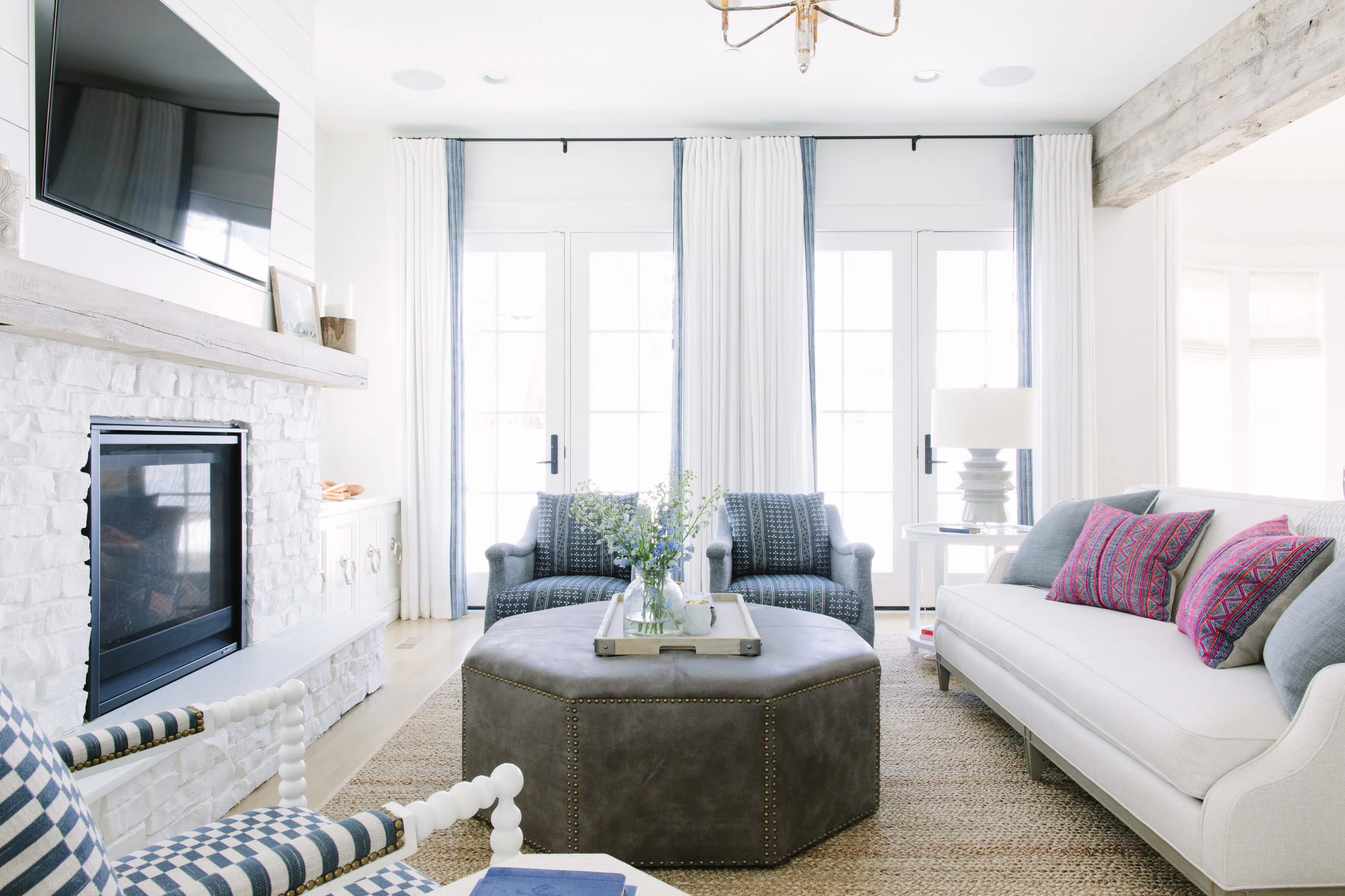 A large natural fiber rug adds warmth and texture to any room like in the family room at our #yesifitswhiteclient project
