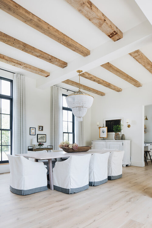 Modern dining room with wood beams and beaded coastal pendant light