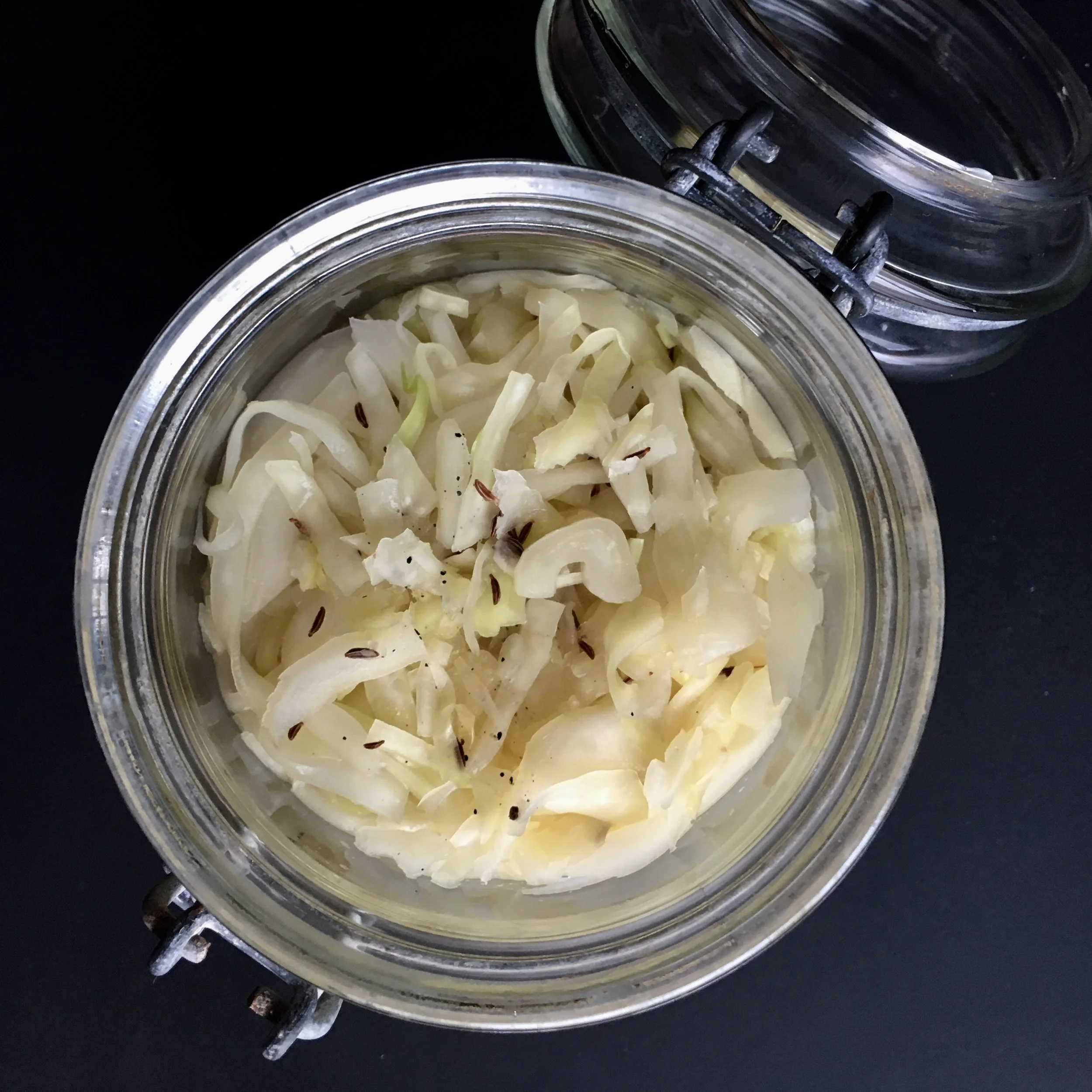 You need to push the cabbage down so there is no air trapped. Don’t fill the jars up to the rim. You need to leave some space for the ceramic pickle weight and the brine.