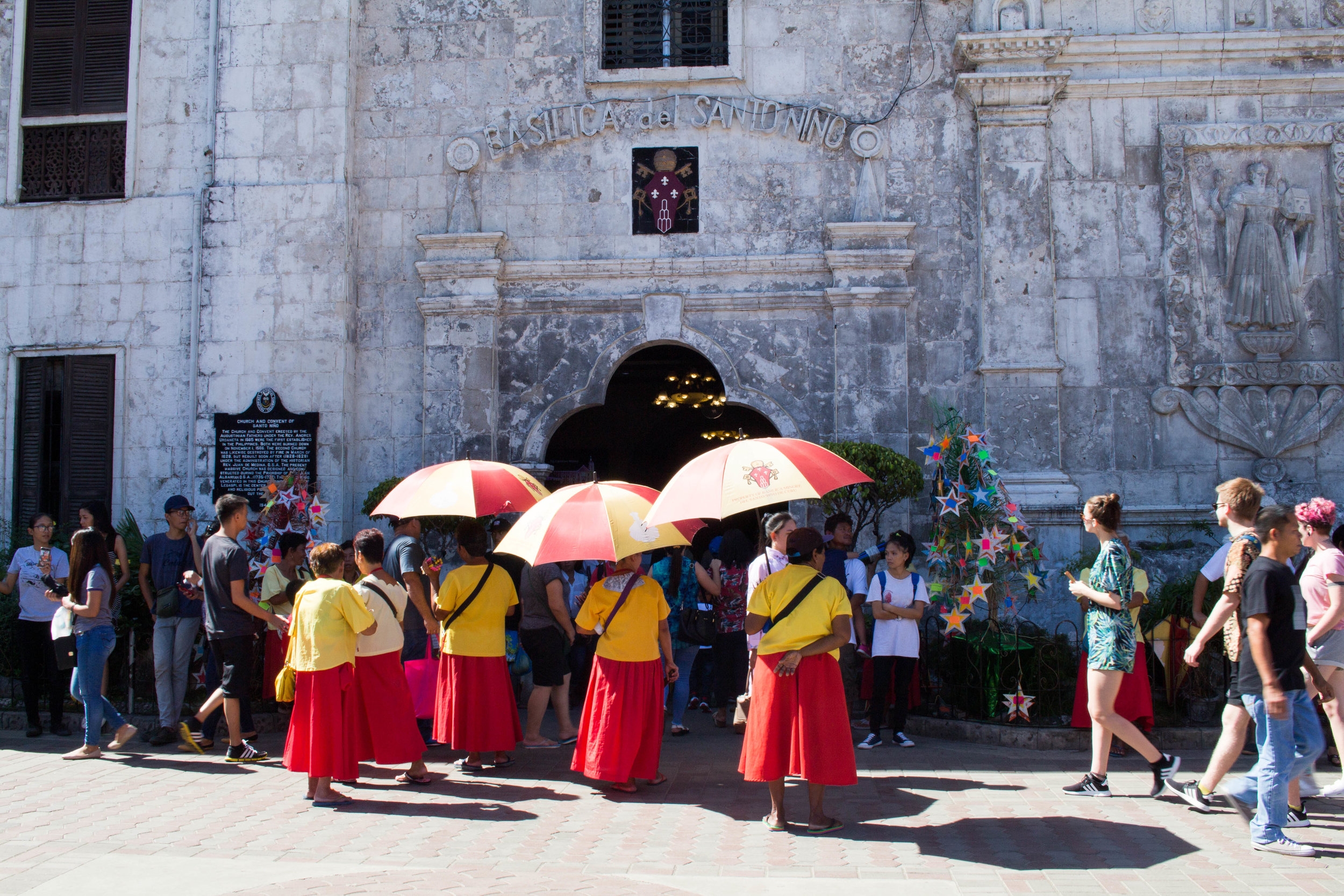 prayer candle vendors standing in front of santo niño basilica