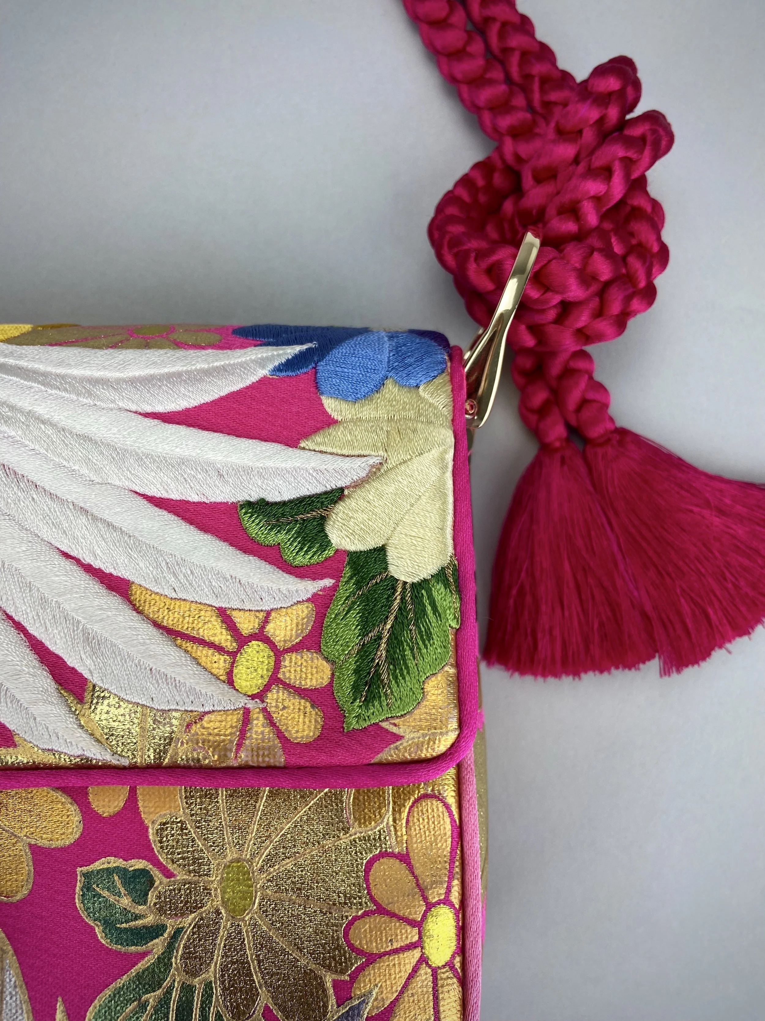 Cherry Pink Crane Feather baguette bag, handmade from vintage Japanese kimono silk with tasseled obijime cord strap by Kirsty Chivers